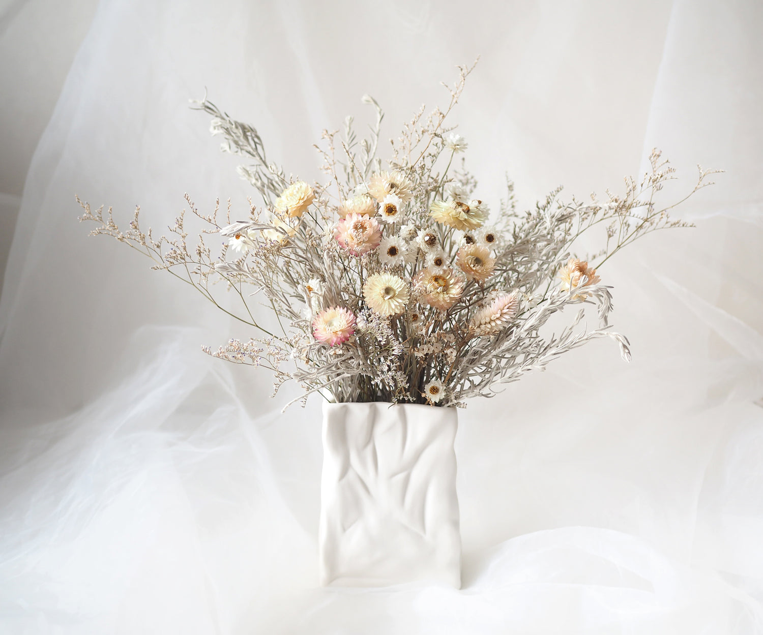 VIVI – white and cream dried flowers in a white ceramic bag vase