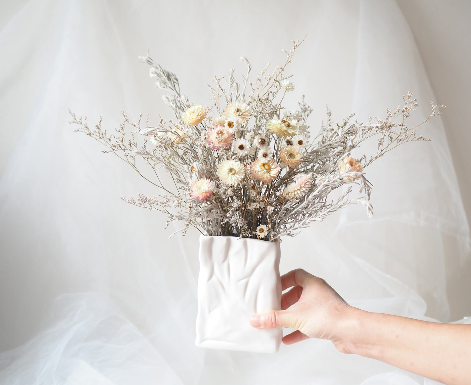 VIVI – white and cream dried flowers in a white ceramic bag vase