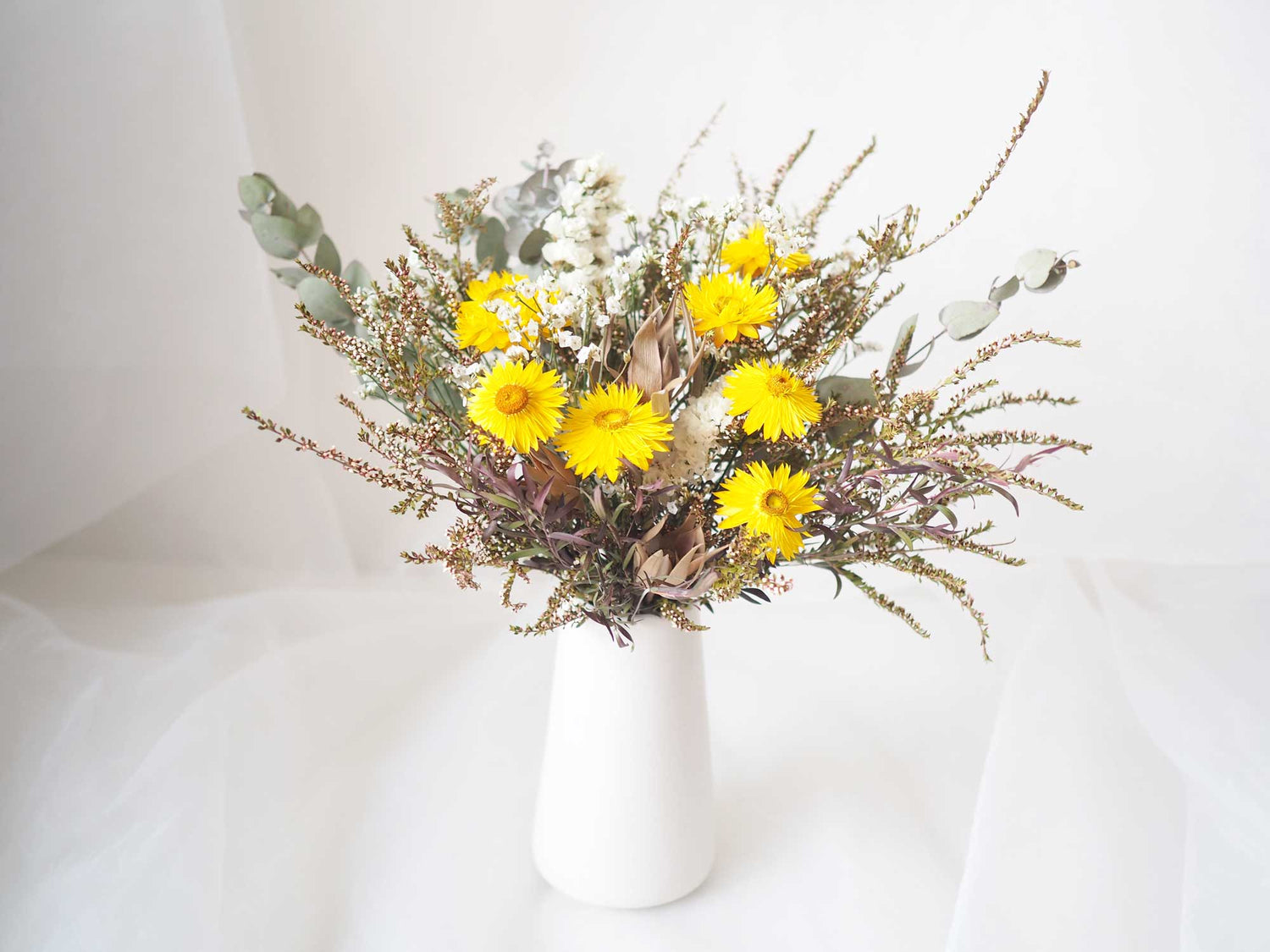 ISA – Yellow White dried flowers in a tall white ceramic vase