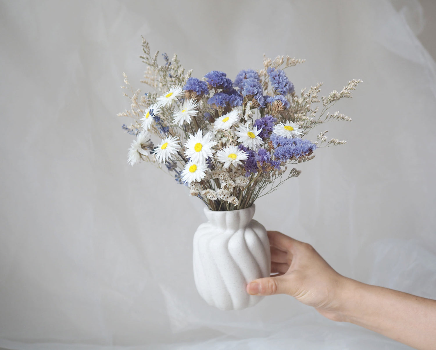 IRIS – white, blue and purple dried flowers in a white ceramic vase