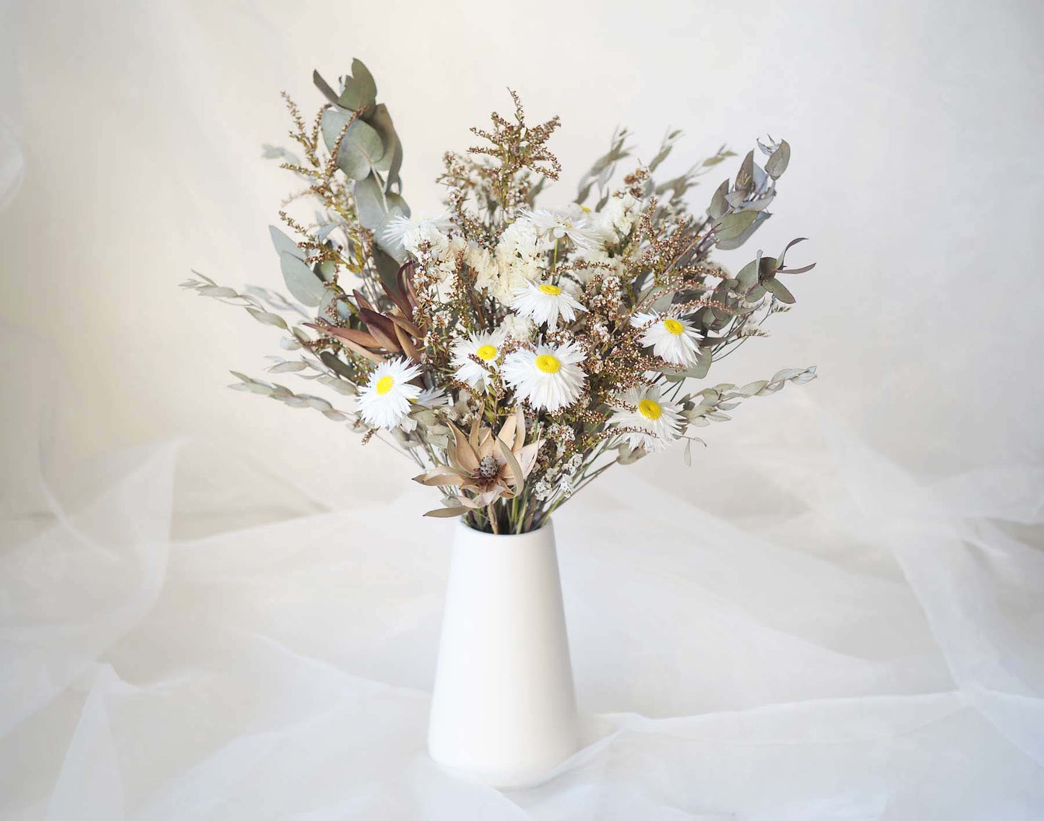 KIRA – native Australian flowers in a tall white ceramic vase