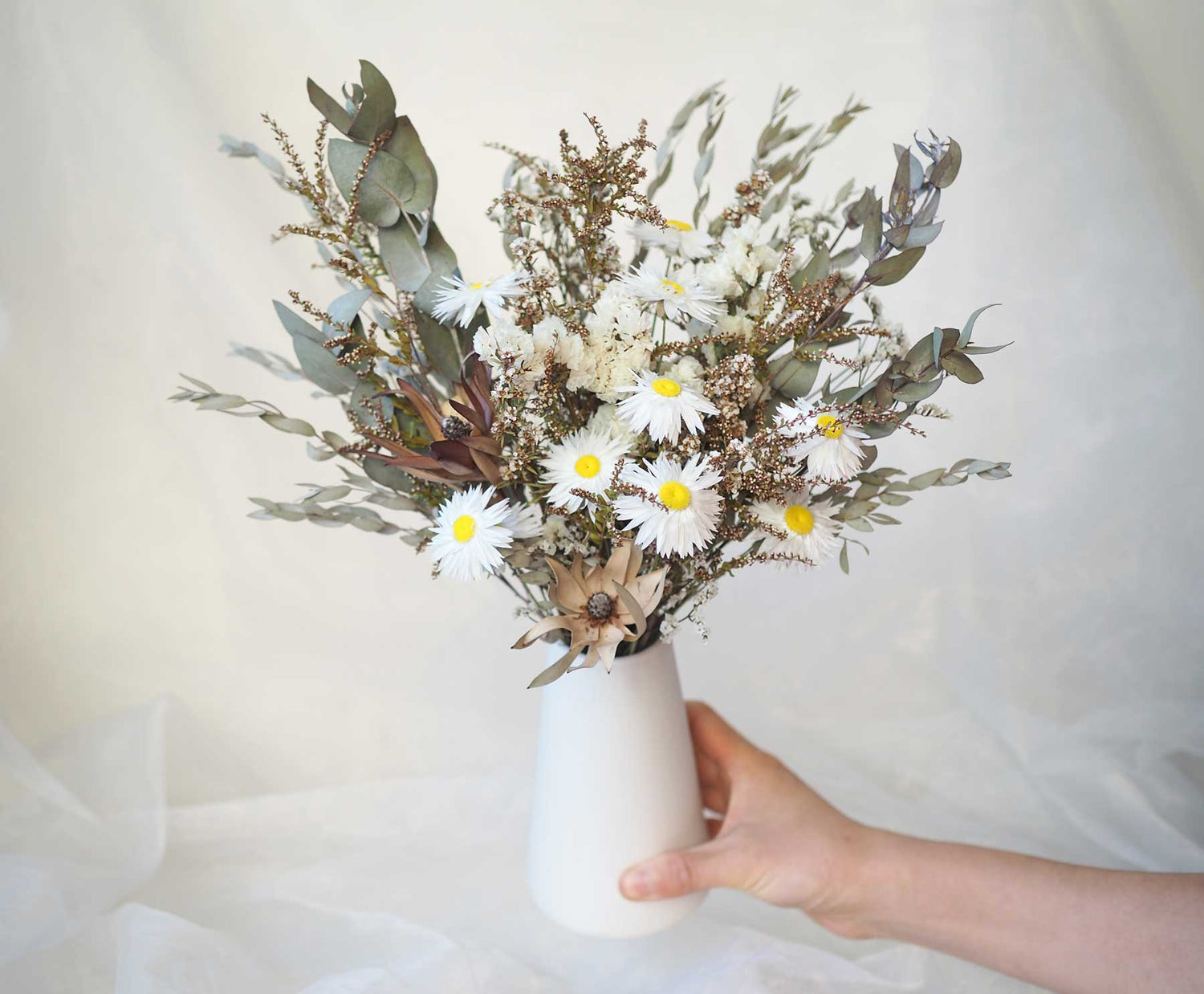 KIRA – native Australian flowers in a tall white ceramic vase