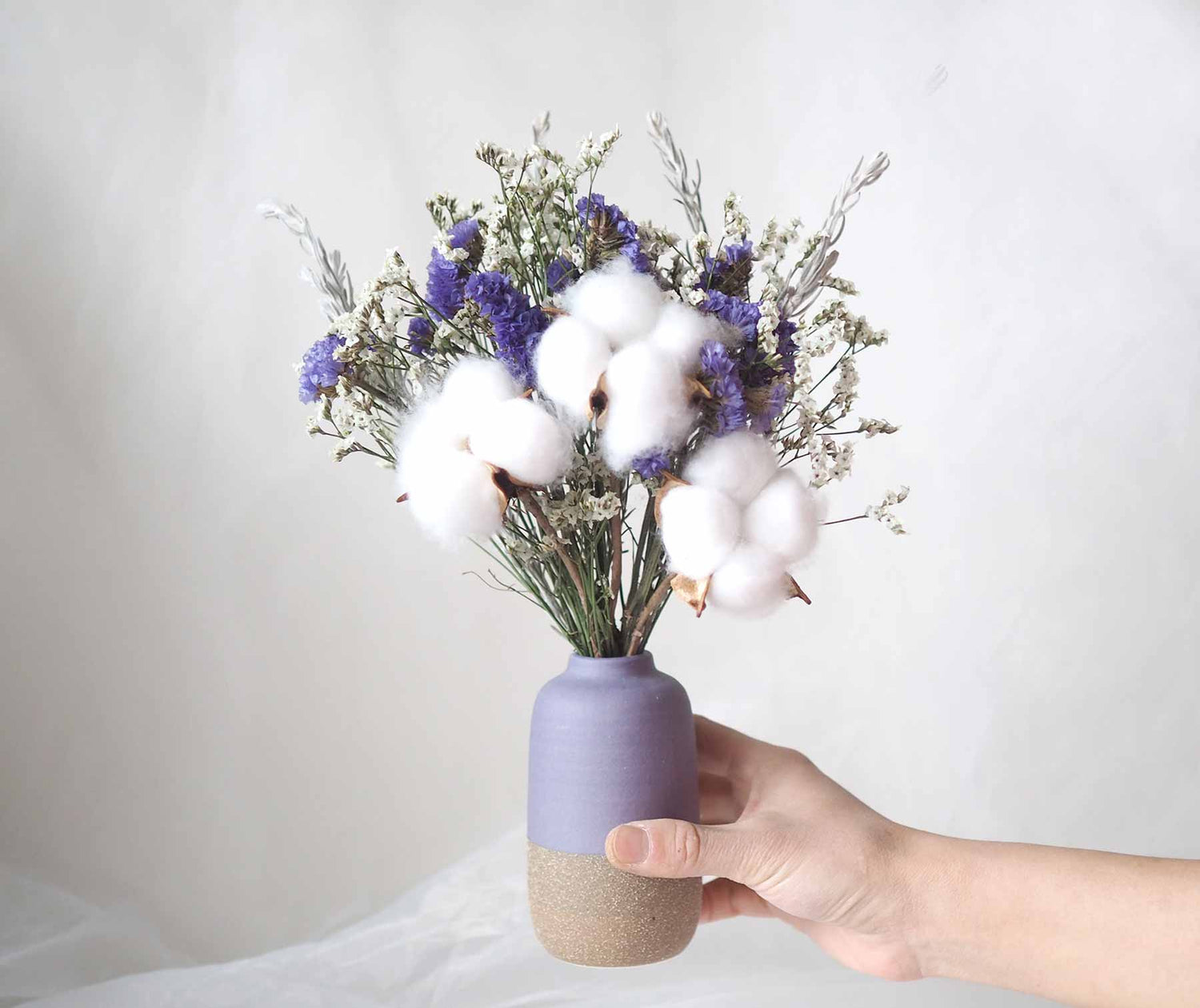 BORA - white dried paper daisies in a purple vase