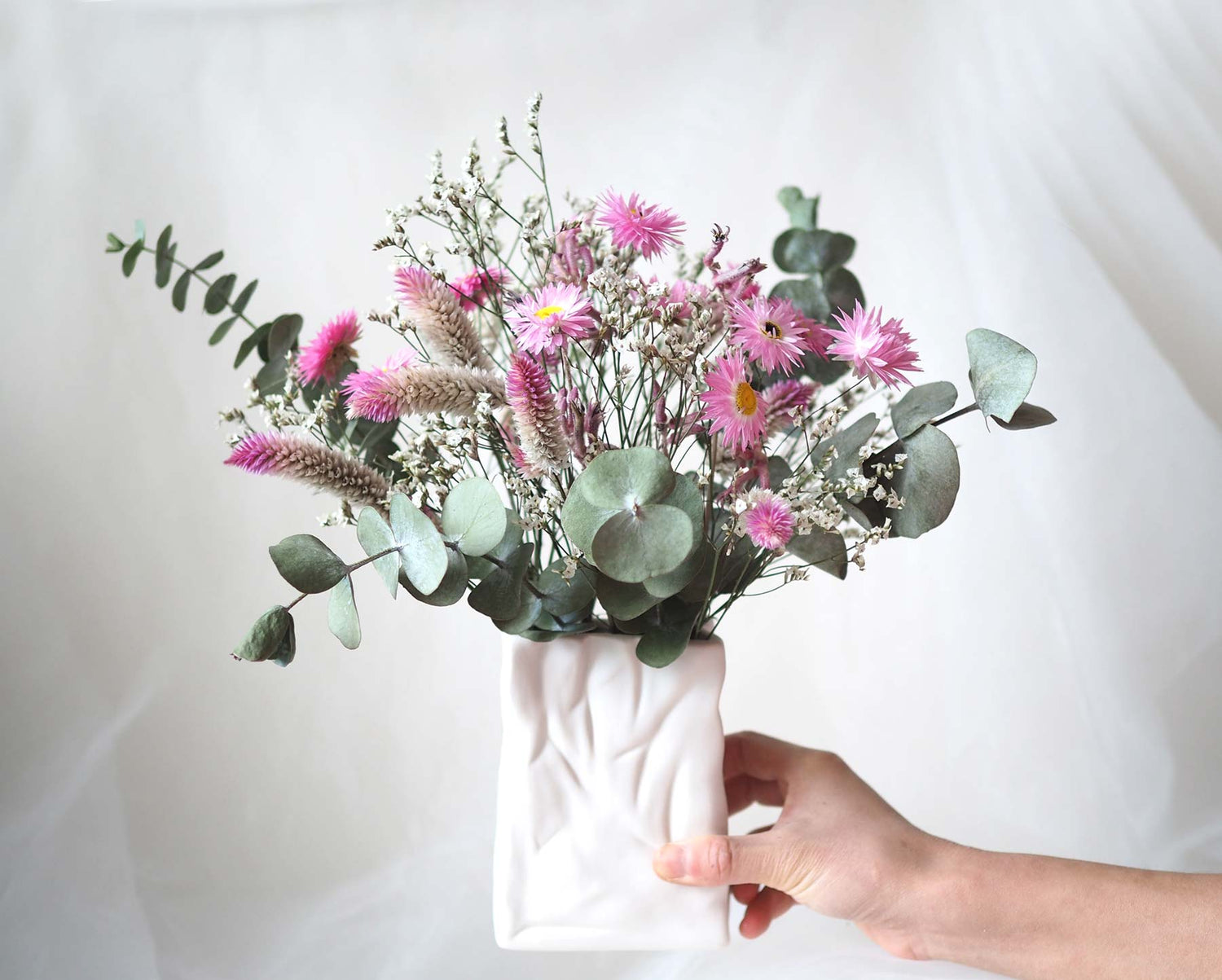 SYLVIE – purple, pink, white and green dried flowers in a white ceramic bag vase